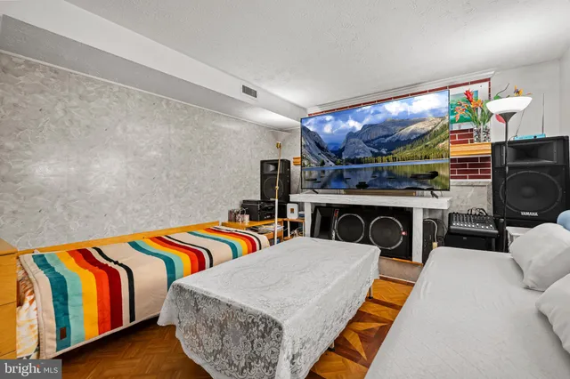 a bed sitting in a bedroom next to a lamp