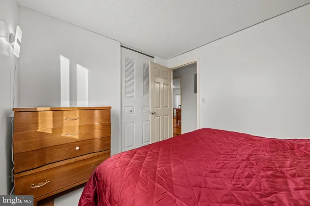 a bedroom with a bed and mirror