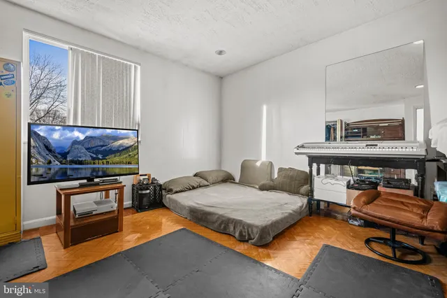 a bedroom with furniture and a flat screen tv
