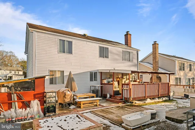 a balcony with wooden floor and outdoor seating