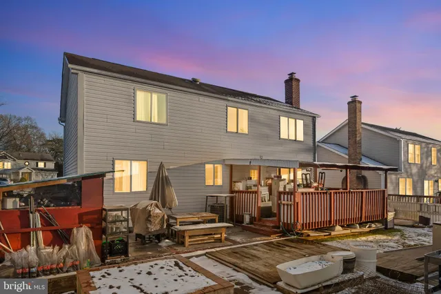 a front view of a house with swimming pool and sitting area
