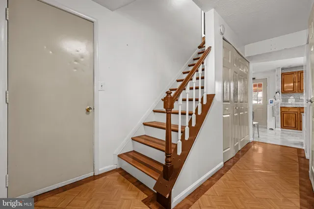 a view of entryway with wooden floor and stairs
