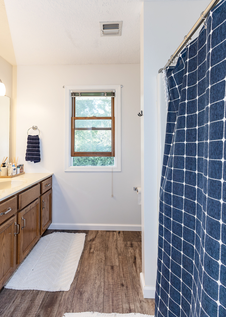 57 Deer Path Court Geneseo, IL 61254 - Photo 19 of 32 a bathroom with a granite countertop sink toilet a mirror and a shower