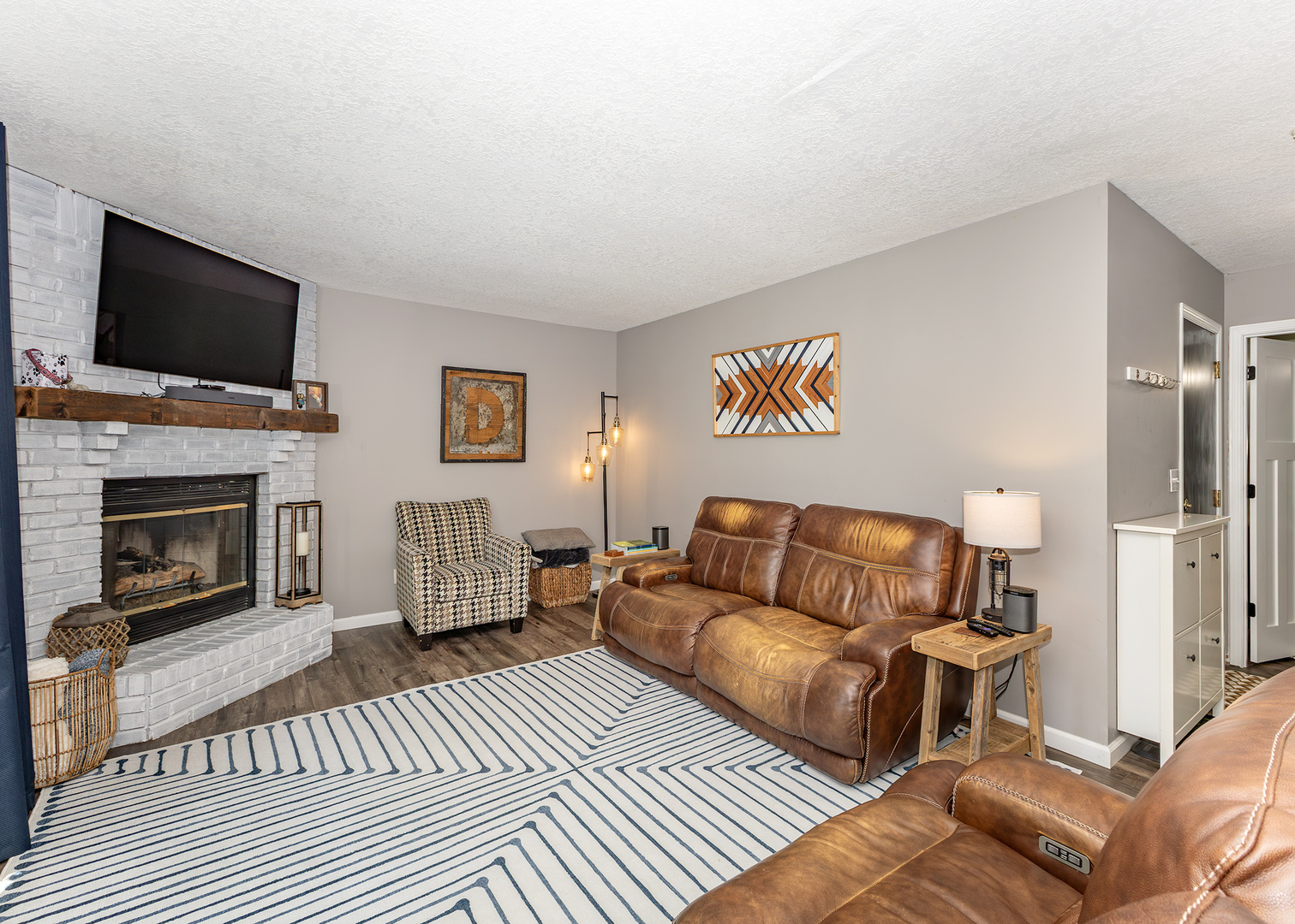 57 Deer Path Court Geneseo, IL 61254 - Photo 8 of 32 a living room with furniture a flat screen tv and a fireplace