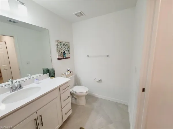 a bathroom with a double vanity sink toilet and shower