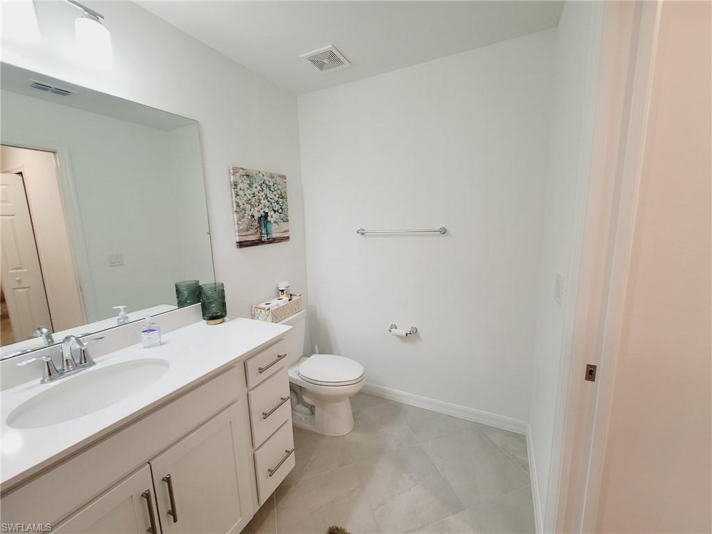 43997 Boardwalk Loop, Unit 1832 Babcock Ranch, FL 33982 - Photo 12 of 22 a bathroom with a sink toilet and a mirror