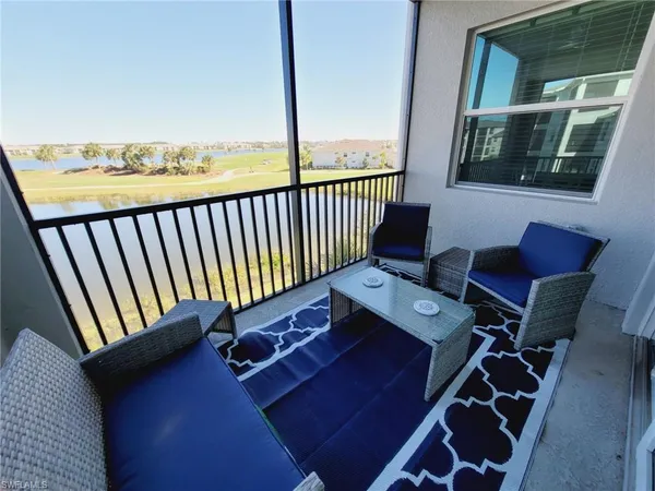 a kitchen with stainless steel appliances a stove a refrigerator a kitchen island a table and chairs