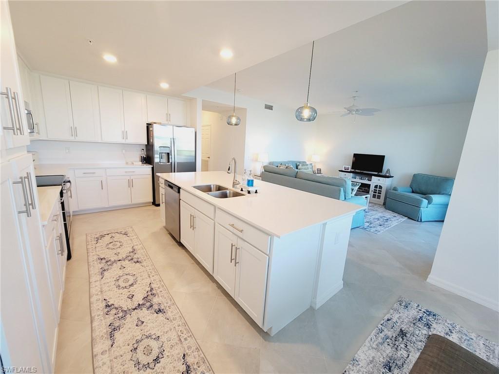 43997 Boardwalk Loop, Unit 1832 Babcock Ranch, FL 33982 - Photo 8 of 22 a kitchen with a sink stove and refrigerator