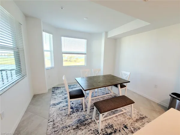 a large bed sitting in a bedroom next to a lamp