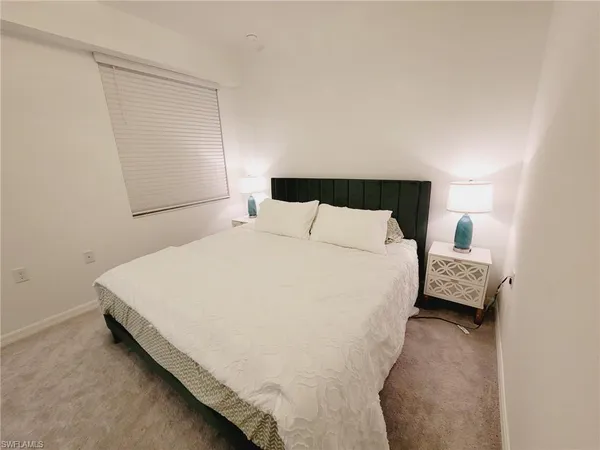 a bedroom with a bed and a mirror