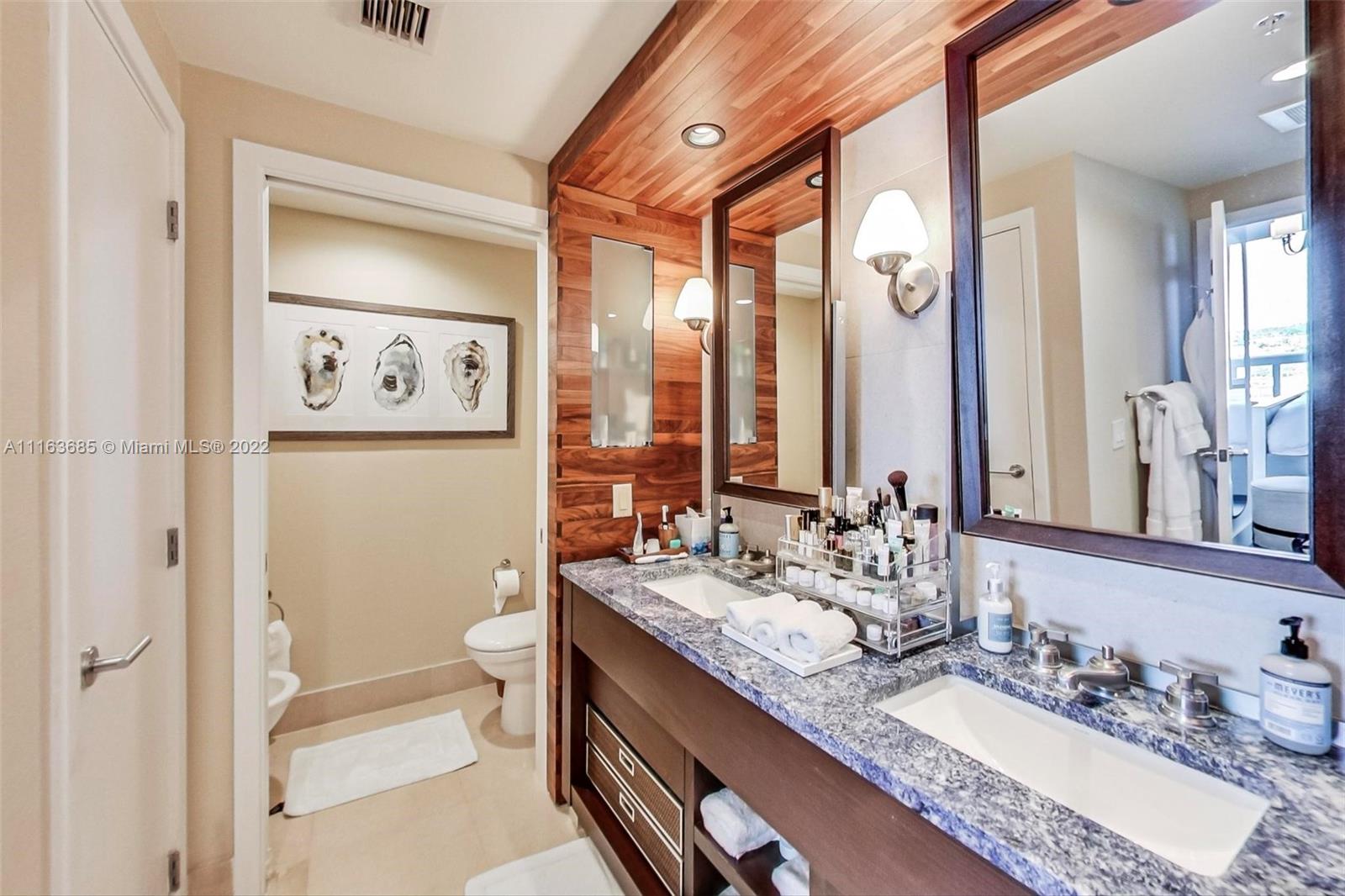 6899 Collins Avenue, Unit 910 Miami Beach, FL 33141 - Photo 19 of 46 a bathroom with a granite countertop sink toilet and shower