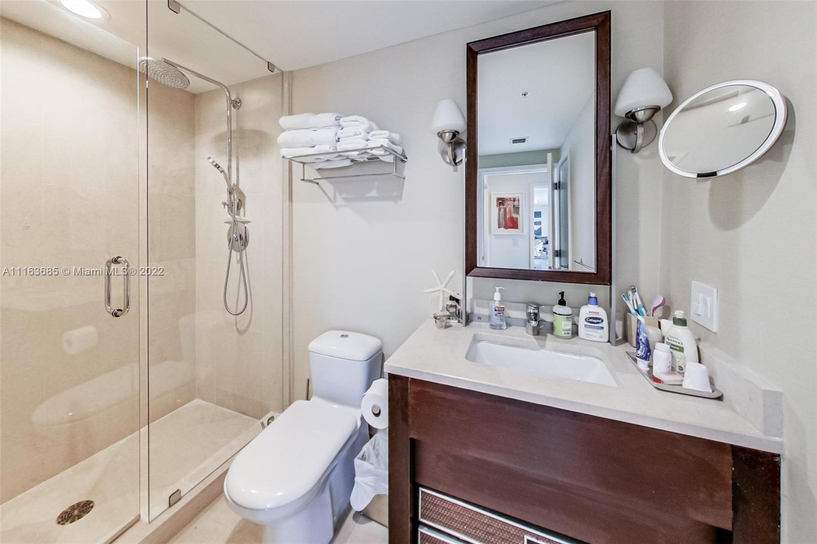 6899 Collins Avenue, Unit 910 Miami Beach, FL 33141 - Photo 25 of 46 a bathroom with a sink toilet and shower