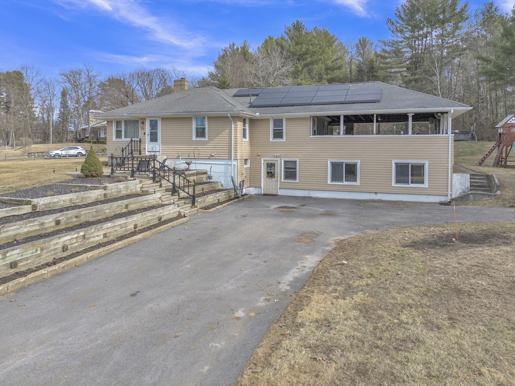 109 North Brookfield Road Barre, MA 01005 - Photo 1 of 42 a view of a white house with large windows next to a yard