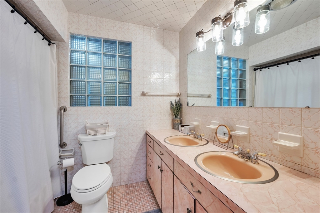 109 North Brookfield Road Barre, MA 01005 - Photo 14 of 42 a bathroom with a toilet a sink a mirror a window and vanity