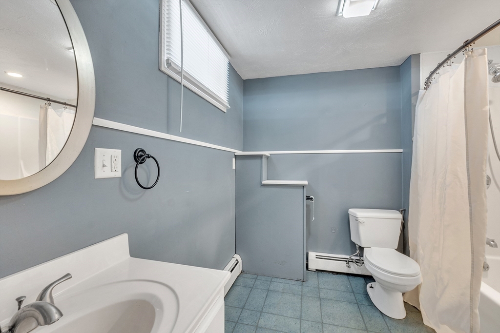 109 North Brookfield Road Barre, MA 01005 - Photo 27 of 42 a white toilet sitting next to a bathroom sink and a mirror