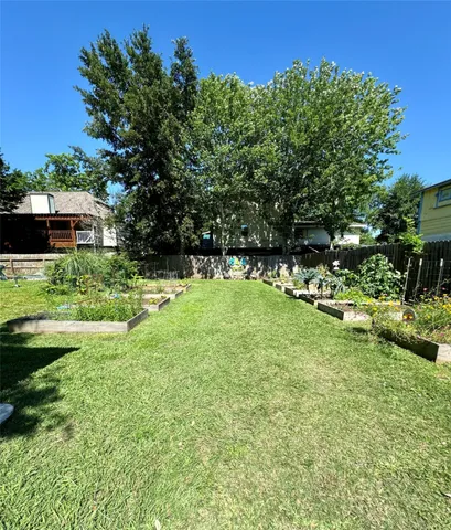 a view of a house with pool and a yard