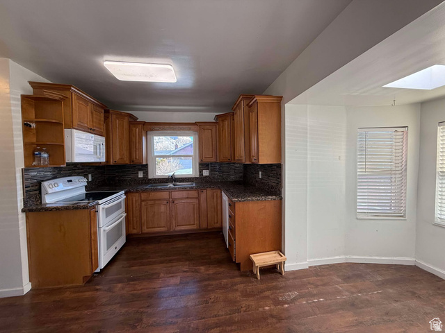 73 Garden Street Helper, UT 84526 - Photo 11 of 36 Kitchen with wood finish cabinetry, white appliances, dark wood finished floors, open shelves, and dark stone countertops