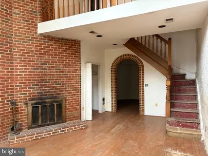a view of a livingroom with entryway and stairs