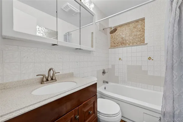 a bathroom with a sink a toilet and bathtub