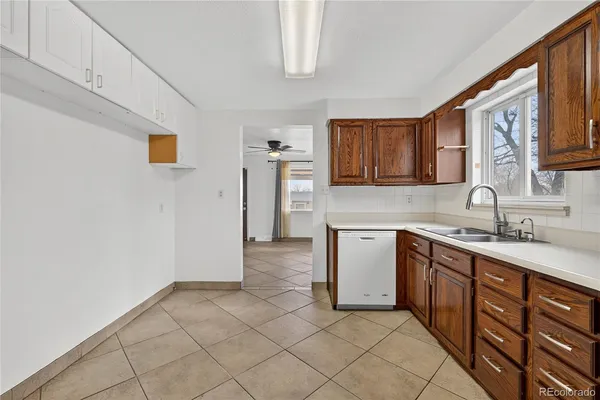 a kitchen with a sink cabinets and a window