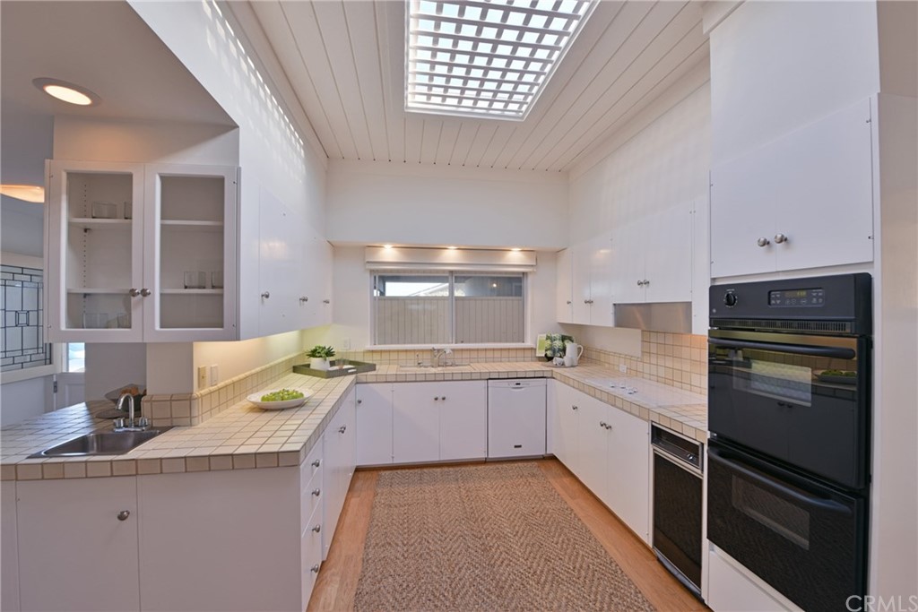 408 Monarch Bay Drive Dana Point, CA 92629 - Photo 16 of 42 a kitchen with a sink stove and cabinets