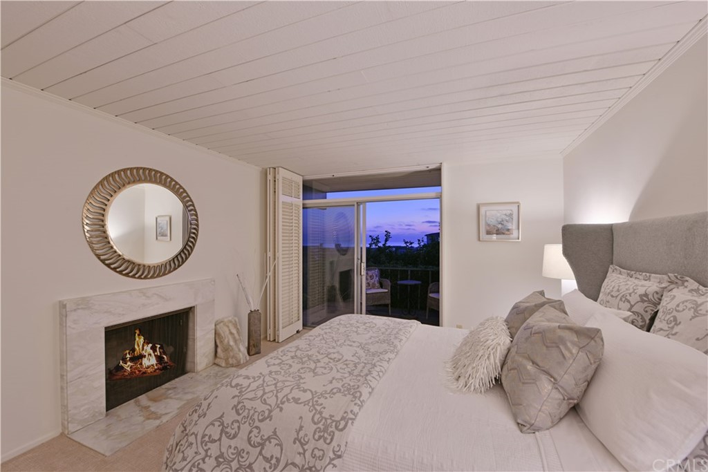 408 Monarch Bay Drive Dana Point, CA 92629 - Photo 21 of 42 a bedroom with a bed and a fireplace