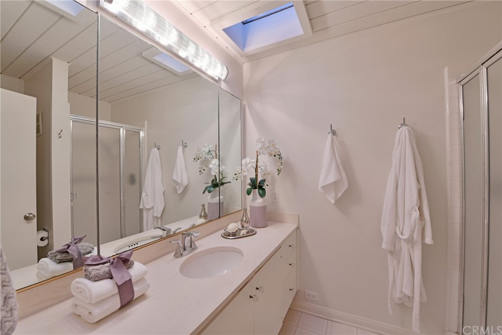 408 Monarch Bay Drive Dana Point, CA 92629 - Photo 22 of 42 a bathroom with a double vanity sink and a mirror