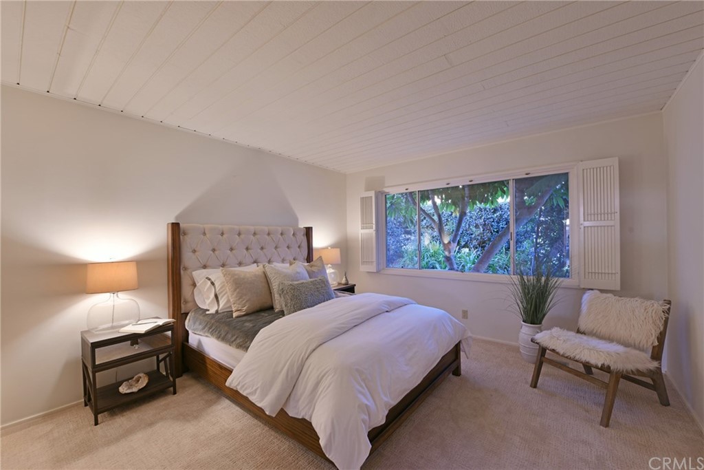 408 Monarch Bay Drive Dana Point, CA 92629 - Photo 24 of 42 a bedroom with a bed and a chair