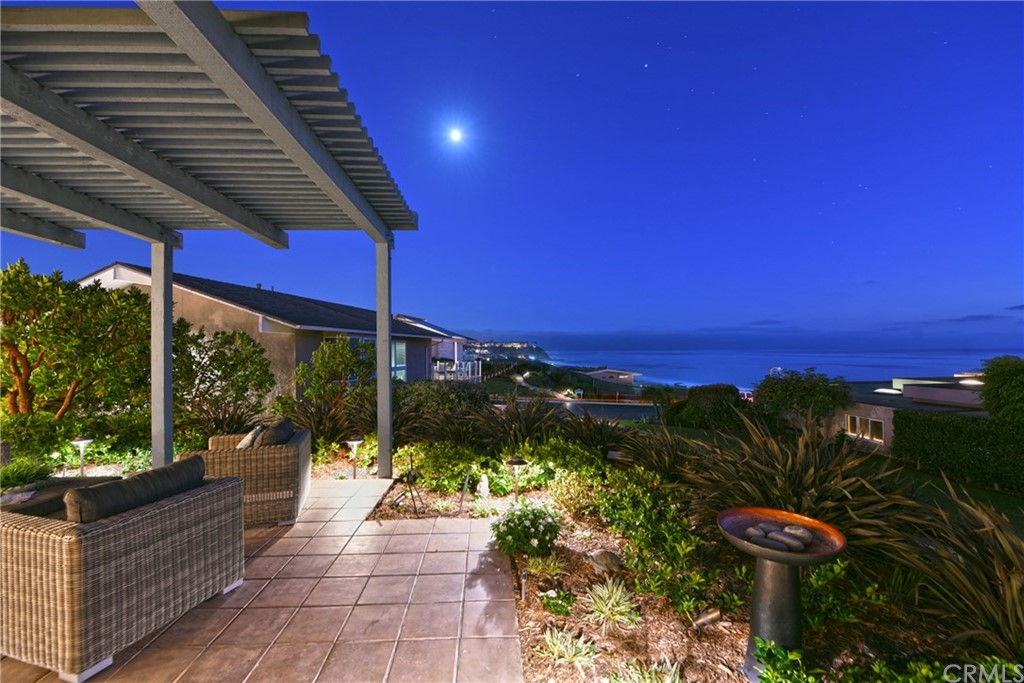 408 Monarch Bay Drive Dana Point, CA 92629 - Photo 27 of 42 a view of a patio with a table and chairs under an umbrella