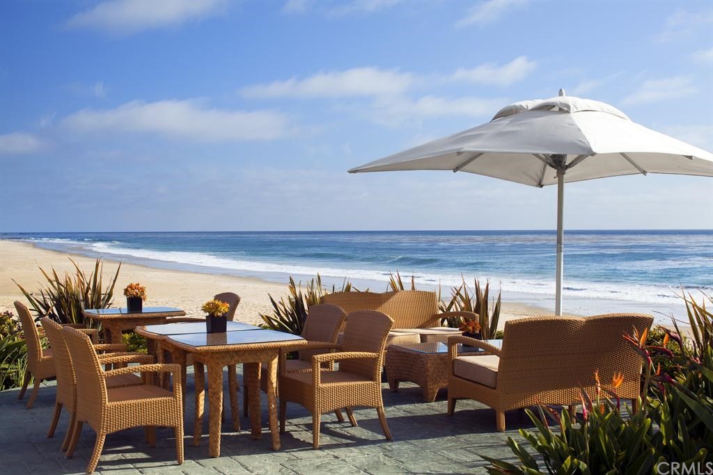 408 Monarch Bay Drive Dana Point, CA 92629 - Photo 37 of 42 a roof deck with table and chairs under an umbrella