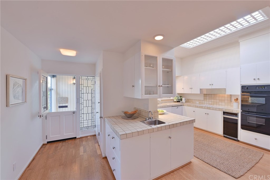 408 Monarch Bay Drive Dana Point, CA 92629 - Photo 6 of 42 a kitchen with a sink stove and cabinets