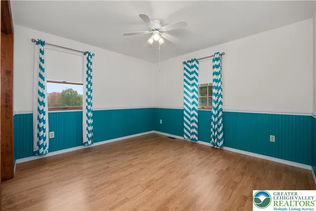 a view of an empty room with a fan