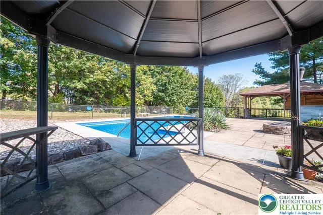a view of a porch with chairs and backyard of the house