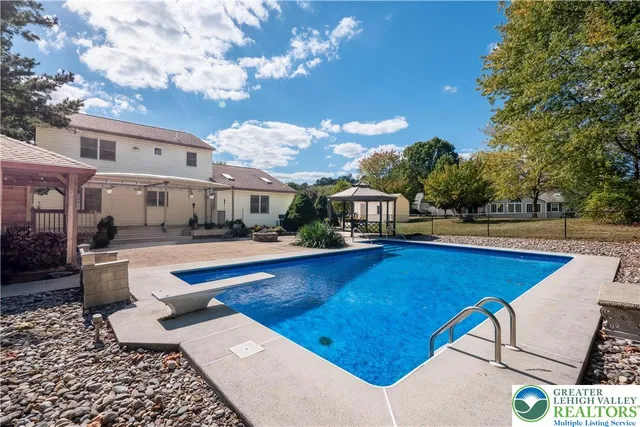 a view of a swimming pool with lounge chair