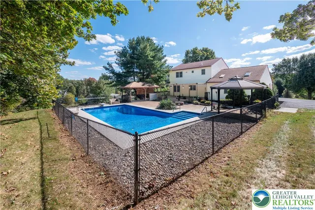aerial view of a house with swimming pool and furniture