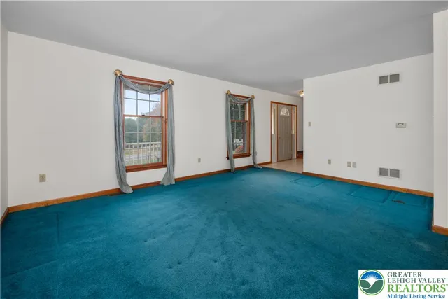 a view of an empty room with closet