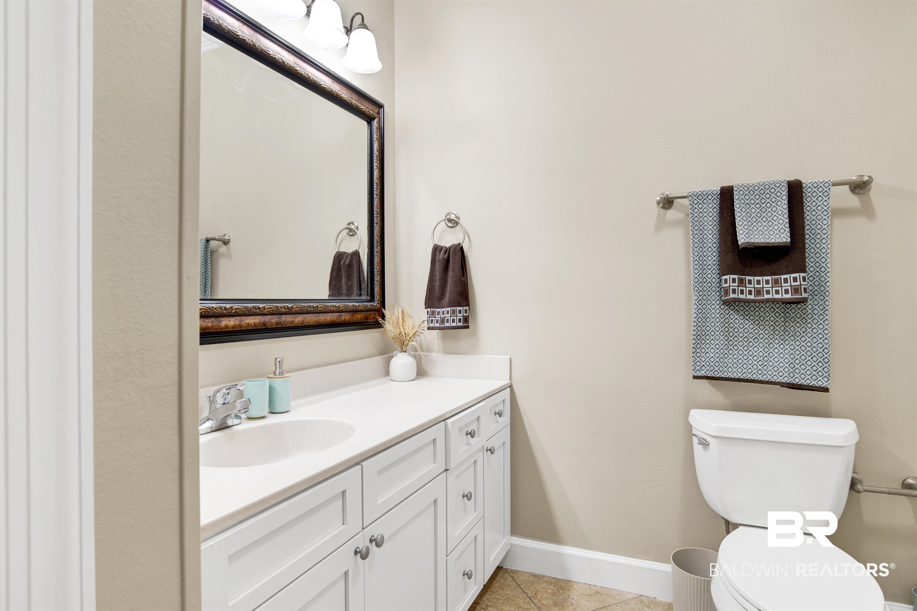 450 Park Avenue, Unit 202 Foley, AL 36535 - Photo 9 of 18 Half bathroom with vanity and light tile patterned floors