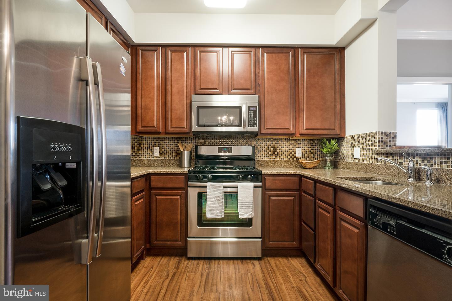 923 Halifax Place Hamilton, NJ 08619 - Photo 15 of 19 a kitchen with granite countertop wooden cabinets stainless steel appliances and a sink