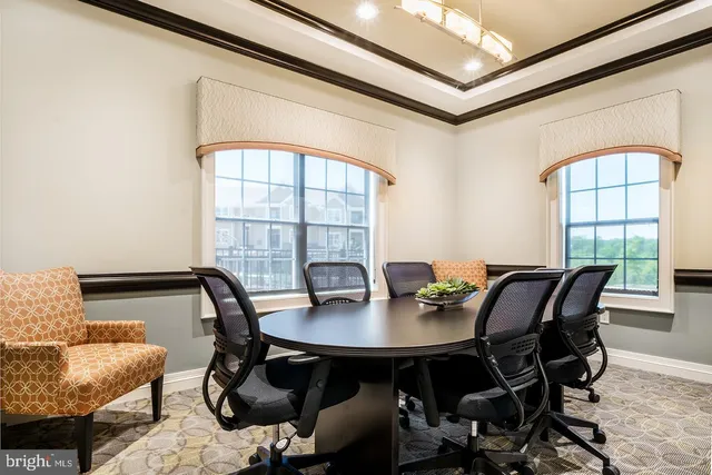 a view of a dining room with furniture and window