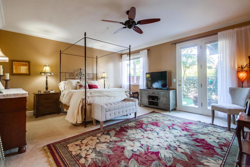 864 Del Mar Downs Road Solana Beach, CA 92075 - Photo 13 of 20 a bed room with a bed a flat screen tv and a fireplace