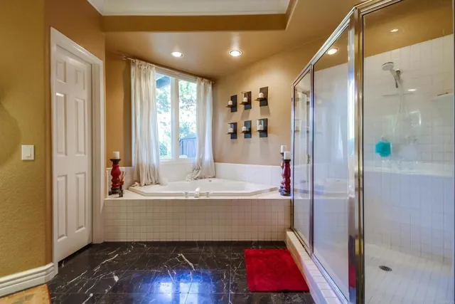 a bathroom with a tub and shower