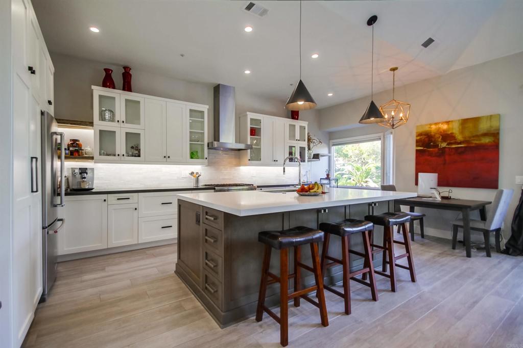 864 Del Mar Downs Road Solana Beach, CA 92075 - Photo 7 of 20 a kitchen with kitchen island granite countertop a sink table and chairs