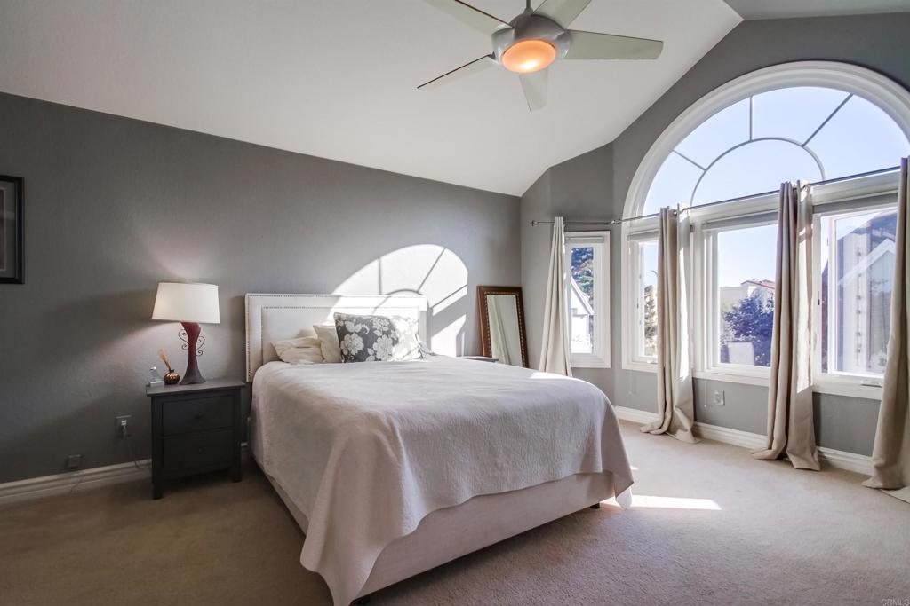 864 Del Mar Downs Road Solana Beach, CA 92075 - Photo 9 of 20 a bedroom with a large bed and a chandelier