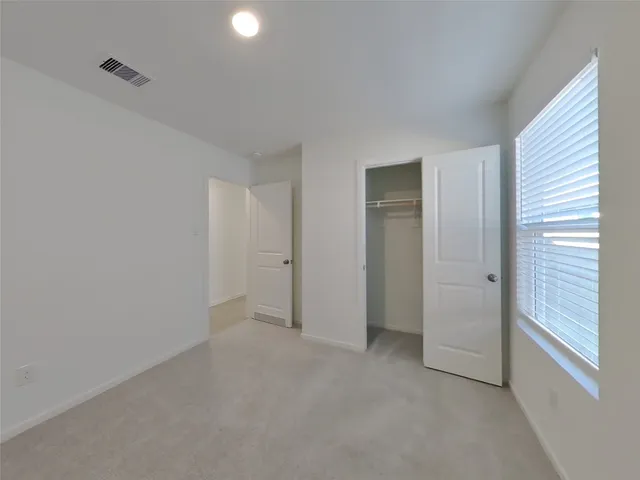 a view of an empty room and closet area