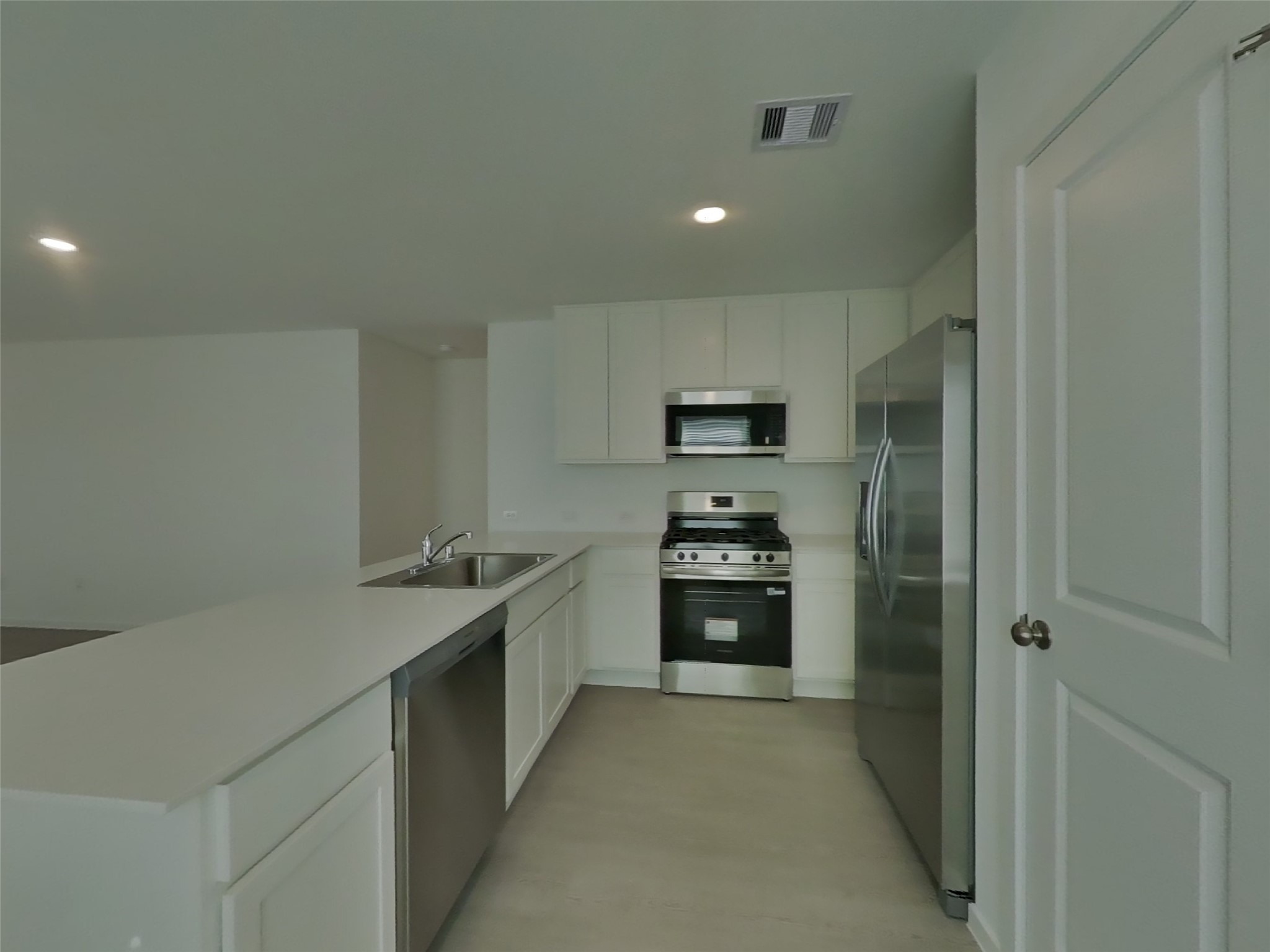 13035 Shells Lane Crosby, TX 77532 - Photo 5 of 17 a kitchen with stainless steel appliances a sink stove and refrigerator