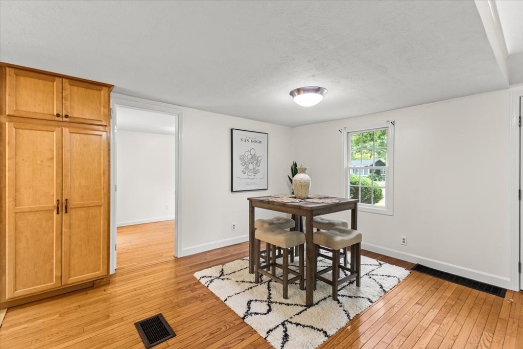 83 River Road Norfolk, MA 02056 - Photo 17 of 27 a view of a dining room with furniture and wooden floor
