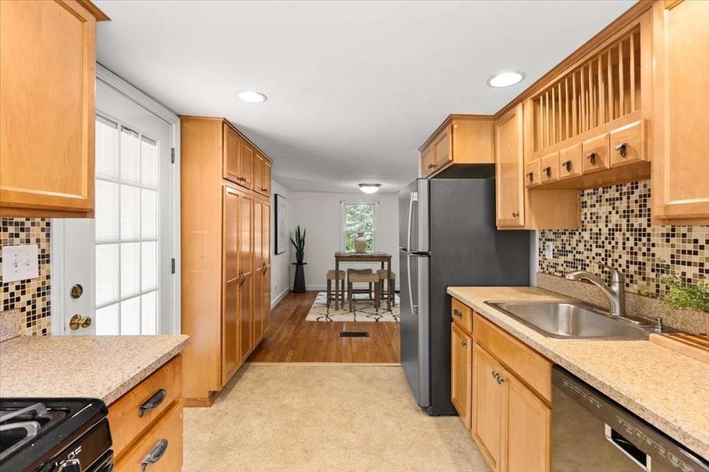 83 River Road Norfolk, MA 02056 - Photo 18 of 27 a kitchen with stainless steel appliances granite countertop a sink stove and refrigerator