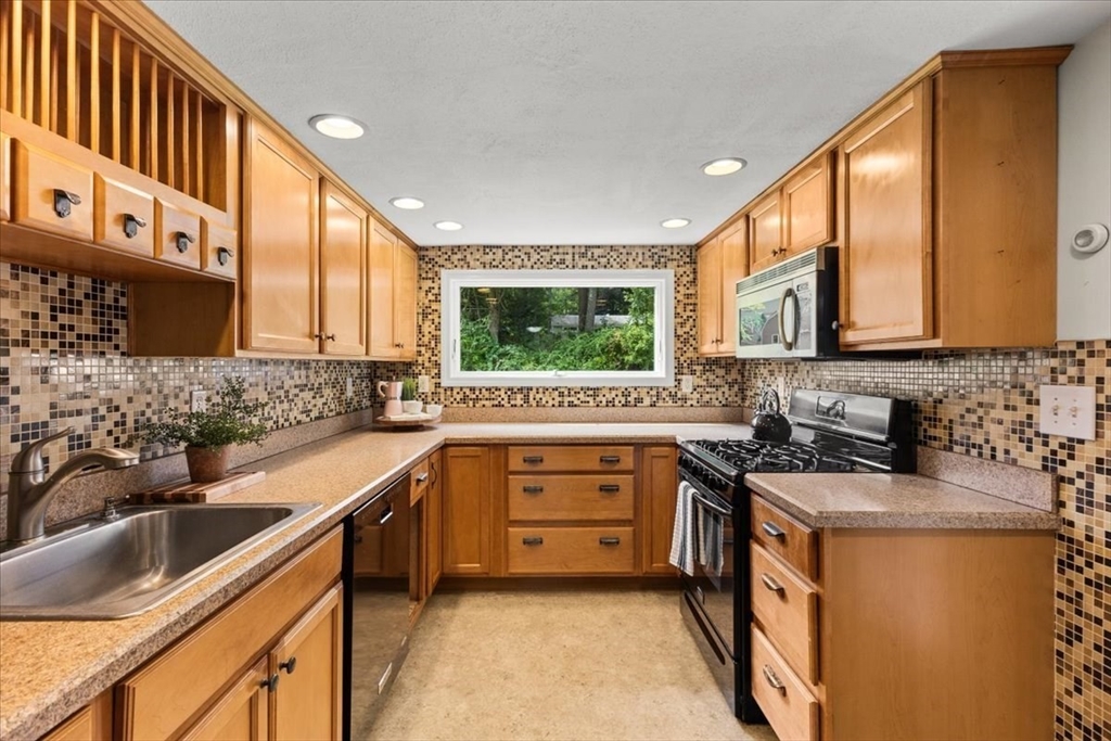 83 River Road Norfolk, MA 02056 - Photo 19 of 27 a kitchen with a sink a window and appliances