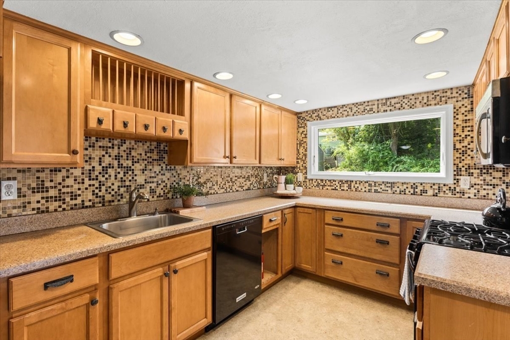 83 River Road Norfolk, MA 02056 - Photo 20 of 27 a kitchen with a sink stove and cabinets
