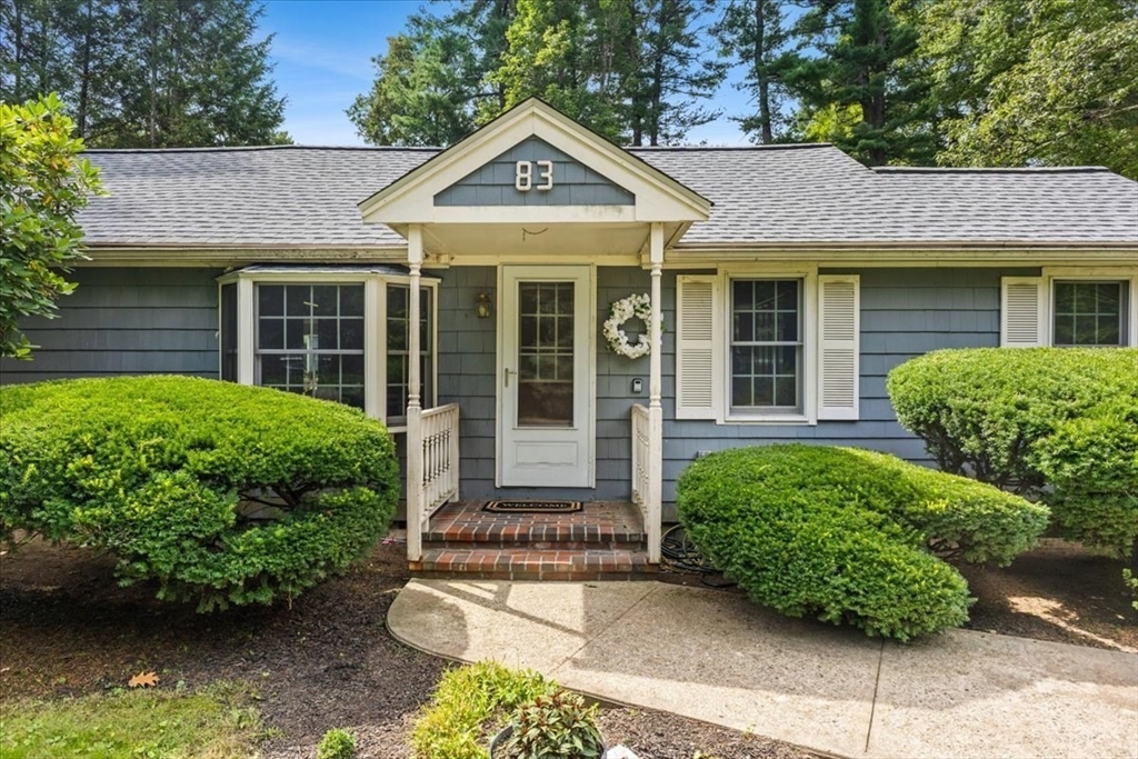 83 River Road Norfolk, MA 02056 - Photo 2 of 27 front view of a house with a garden